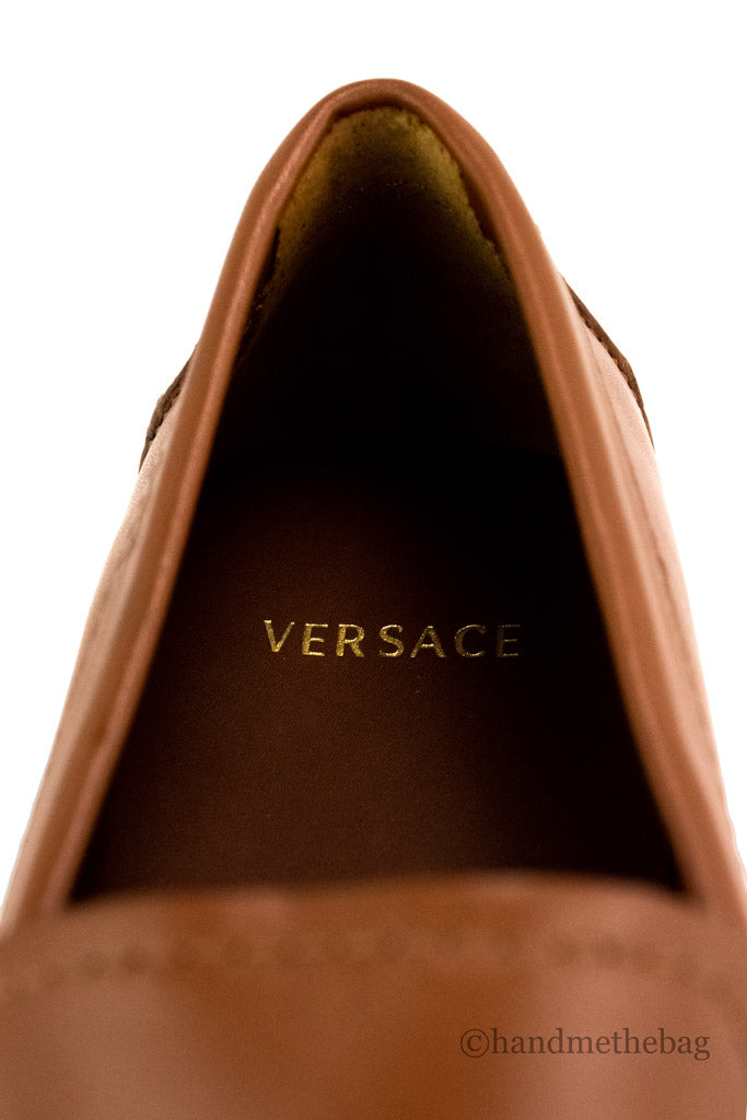 versace warm brown drivers detail on white background