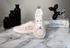 gianni versace powder blush sneakers posed on marble table