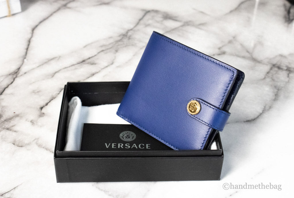 versace navy blue compact bifold wallet in box on marble table