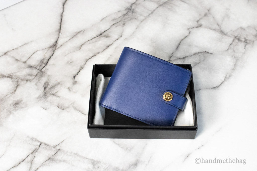 versace navy blue compact bifold wallet in box on marble table