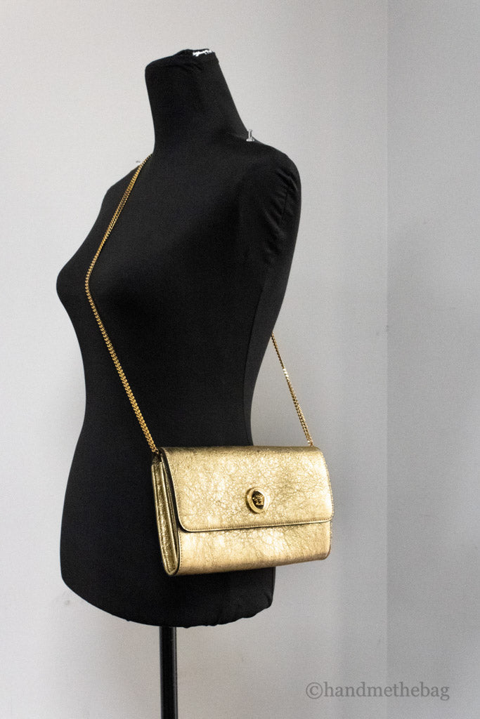 versace metallic gold evening bag on mannequin
