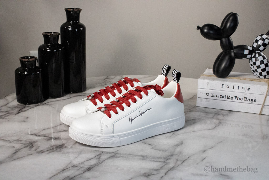 gianni versace deep red sneakers on marble table