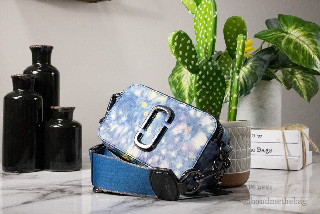 marc jacobs the watercolor snapshot crossbody on marble table