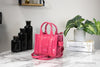 marc jacobs magenta the shiny crinkle micro tote on marble table