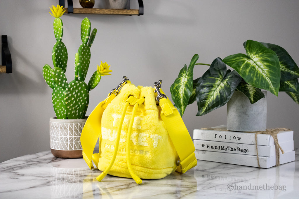 marc jacobs the terry mini bucket bag yellow on marble table