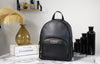 michael kors jaycee medium black backpack on marble table