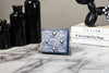 mcm veritas antique denim blue bifold wallet on marble table
