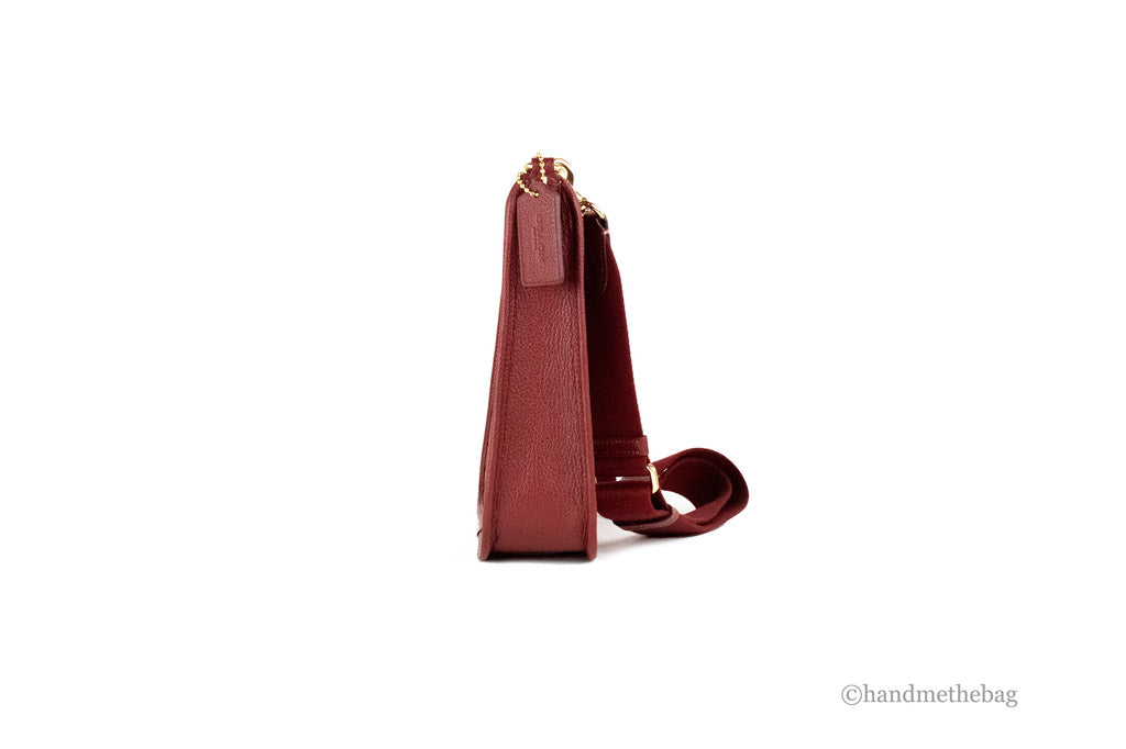 coach dempsey red apple file crossbody side on white background