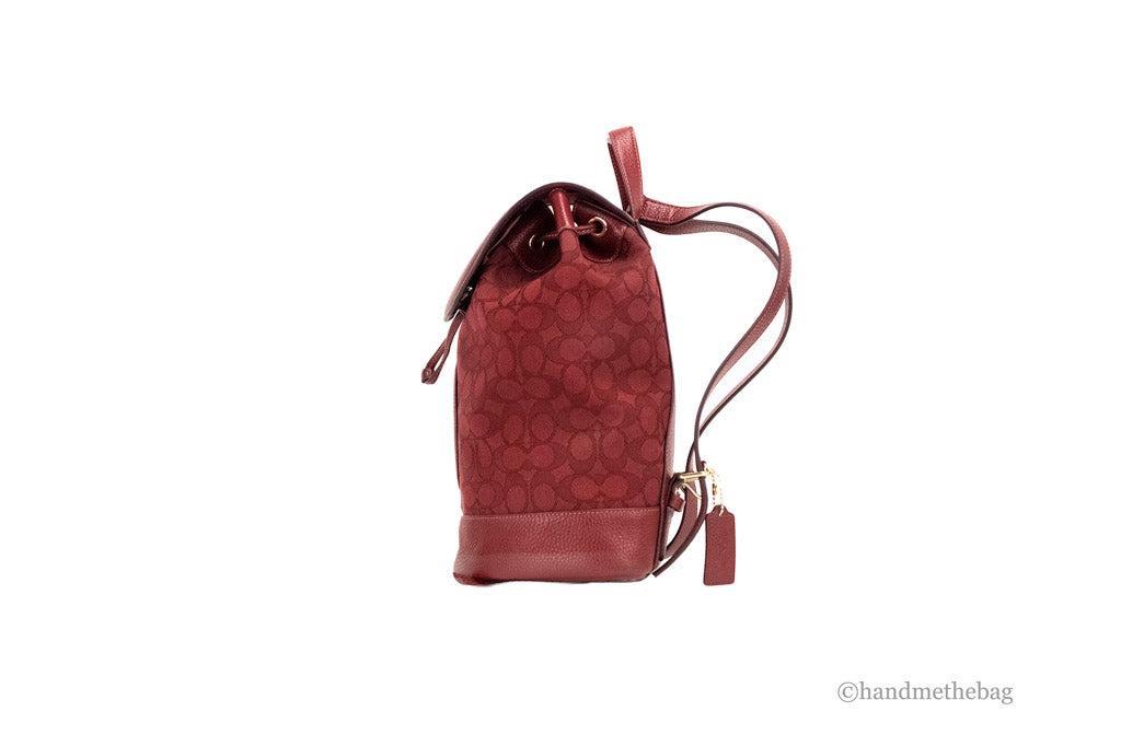 coach dempsey red apple canvas backpack side on white background