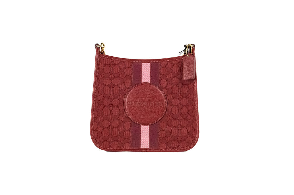 coach dempsey red apple file crossbody on white background