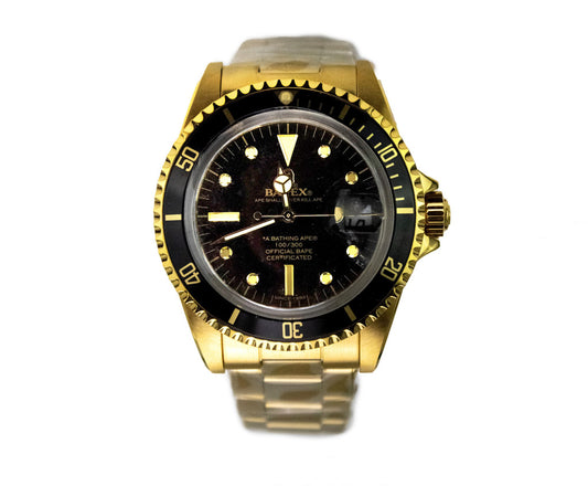 bapex type 1 gold tone black dial watch on white background